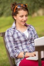 Girl using laptop sitting bench at park Royalty Free Stock Photo