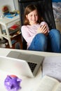 Girl Using Mobile Phone Instead Of Studying In Bedroom Royalty Free Stock Photo