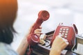 A girl using the red vintage telephone Royalty Free Stock Photo