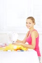 Girl using sewing machine to sew clothing