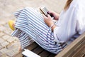 Girl using phone while charging on the power bank Royalty Free Stock Photo