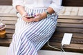 Girl using phone while charging on the power bank Royalty Free Stock Photo