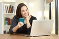 Girl using a smart phone and laptop on a table at home