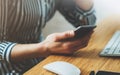 Girl using smartphone in indoors workplace at home, woman touch on screen phone in business office, freelance commucation online Royalty Free Stock Photo