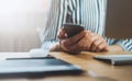 Girl using smartphone in indoors workplace at home, woman touch on screen phone in business office, freelance commucation online Royalty Free Stock Photo