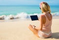 Girl using tablet on the beach Royalty Free Stock Photo