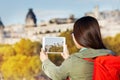 Girl using tablet making picture of autumn Paris