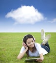 girl using touch pad computer with headphone