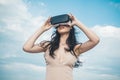 Girl using VR headset. Woman getting experience using VR-headset glasses. Visual reality concept. Digital future and