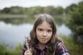 Girl with very serious look in outdoor setting Royalty Free Stock Photo