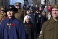 Girl and veterans from different regiments in soft focus wearing vintage nurse and military uniforms