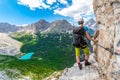 Girl on via ferrata above Sorapis lake in Dolomiti mountains, Italia, Europe