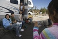 Girl videotaping family outside of RV Royalty Free Stock Photo