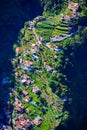 Girl at Viewpoint Eira do Serrado looking to Curral das Freiras village in the Nuns Valley in beautiful mountain scenery,