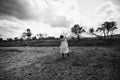 Girl village walks forged field dress hat goes Royalty Free Stock Photo