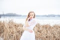 girl in a vintage dress on a river in winter