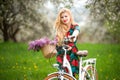 Girl with vintage white bicycle with flowers basket