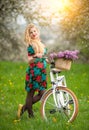 Girl with vintage white bicycle with flowers basket