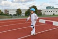 A girl in vintage white roller skates and a helmet at the stadium Royalty Free Stock Photo