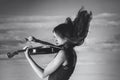 Girl, violin, wind, clouds