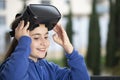 Girl with virtual reality glasses smiling distracted Royalty Free Stock Photo