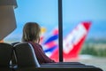 A girl waiting for her flight at the airport