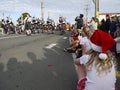 New Zealand: small town Christmas parade girl waiting for Scottish bagpipe band