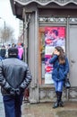 Girl waiting on the street. Top advertisement with a kissing couple