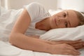 Girl waking up and lying in bed. Royalty Free Stock Photo