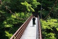 girl walk around on the bridge with strong wind