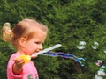 Girl on a walk blows bubbles