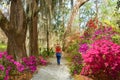 Girl walking alone in beautiful garden on spring trip. Royalty Free Stock Photo