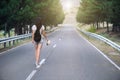 Girl walking alone on mountain highway Royalty Free Stock Photo