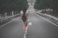 Girl walking alone on mountain highway Royalty Free Stock Photo