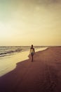 Girl walking along the beach at sunset Royalty Free Stock Photo
