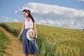 Girl is walking along the road among the fields Royalty Free Stock Photo