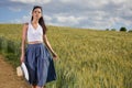 Girl is walking along the road among the fields Royalty Free Stock Photo