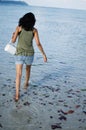 Girl Walking Angrily with her Bag on a Beach Royalty Free Stock Photo