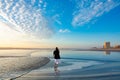 Girl walking on the beach at sunrise in Florida. Royalty Free Stock Photo