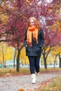 Girl walking in city park, autumn season Royalty Free Stock Photo