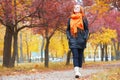 Girl walking in city park, autumn season Royalty Free Stock Photo