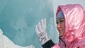 Girl walking on cracked ice of a frozen lake Baikal. Woman trave