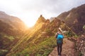 Girl walking down along the trekking route to verdant Xo-Xo valley. Warm sunlight seable on horizont. Santo Antao Island