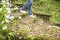 Girl is walking down the old steps overgrown with moss and grass Royalty Free Stock Photo