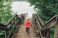 Girl walking down wooden stairs to water at Canadian Ontario Kettles lake in Midland. Canada forest nature.