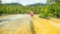 Girl walking on Emerald pool waters near Krabi, Thailand