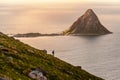 Girl walking in evening light from Matinden with Bleiksoya island in background, Andenes, Vesteralen, Norway Royalty Free Stock Photo