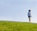 Girl walking on the green hill