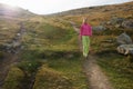 Girl walking on the green hill