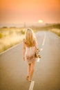 Girl walking with her skateboard